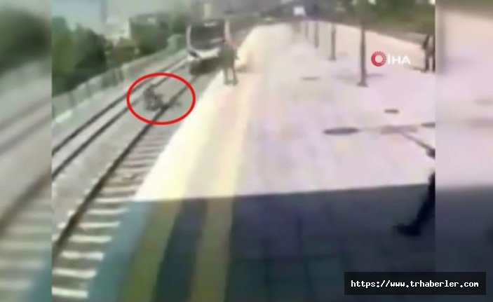 Trenin önüne atlayıp intihar girişiminde bulunan kadını kurtardı - video izle